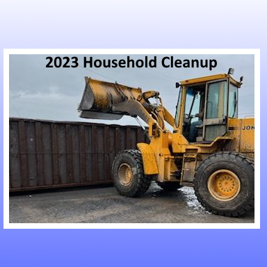 Loader putting junk in dumpster